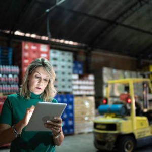 Employee using digital tablet at warehouse